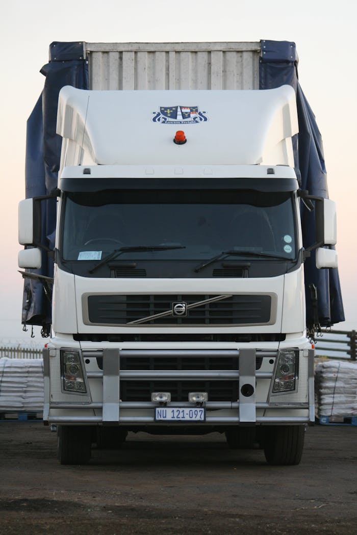 gallery-03 A powerful white truck captured from the front, showcasing its robust design.