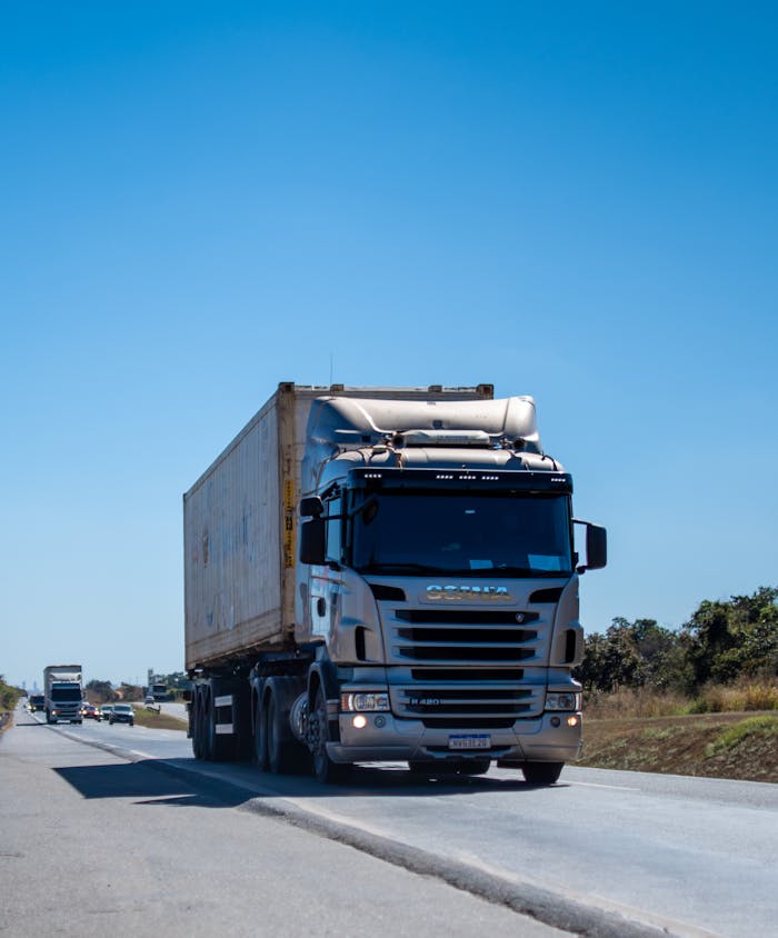home-img A large cargo truck travels on a highway in Brazil under clear blue skies.