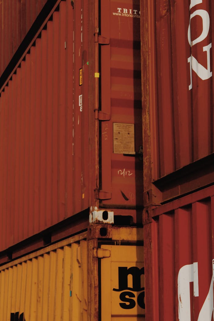 gallery-02 Close-up view of stacked rusty cargo containers highlighting industrial textures.